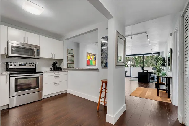 a kitchen with stainless steel appliances a stove a sink and a refrigerator