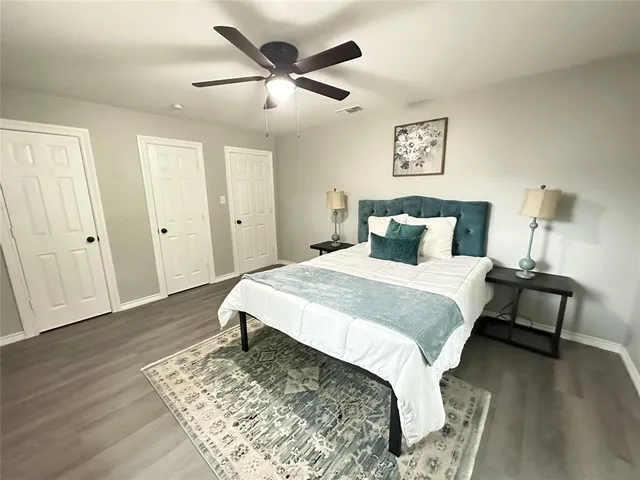 a bedroom with a bed and wooden floor