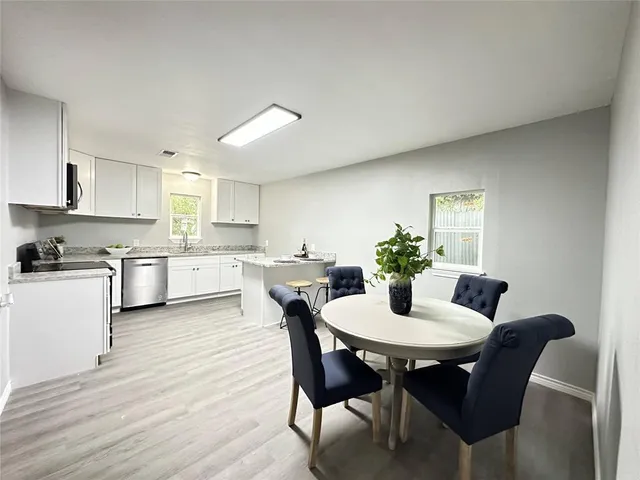 a view of a dining room with furniture and wooden floor
