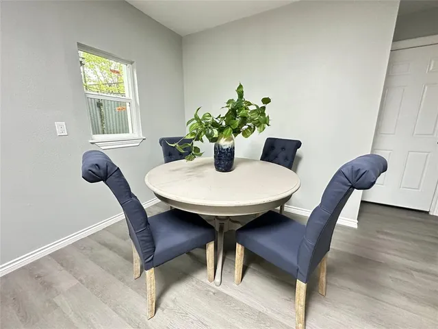 a dining room with furniture and wooden floor
