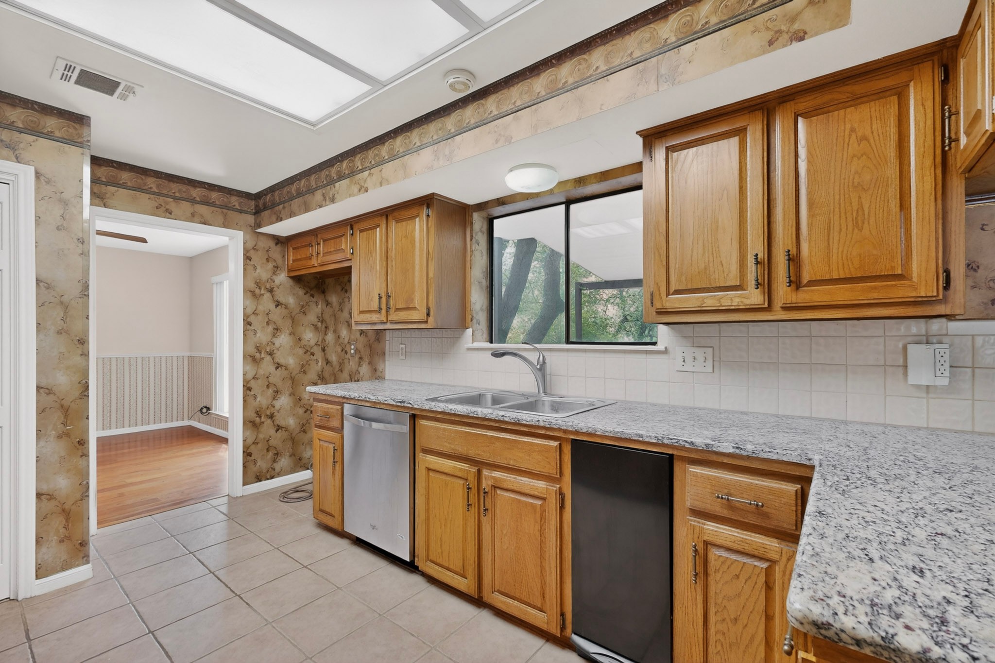 1003 Pier Branch Road Dripping Springs, TX 78620 - Photo 20 of 40 A well-appointed kitchen features ample cabinetry, a double sink, and solid surface countertops.