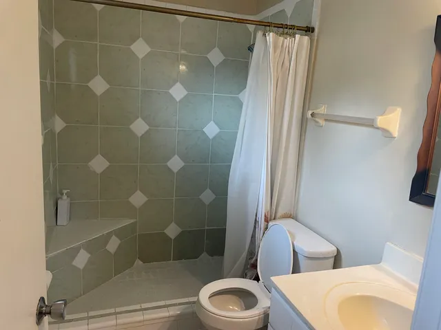 a bathroom with a toilet and shower