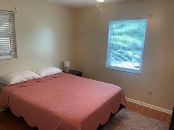 a bedroom with a bed and window