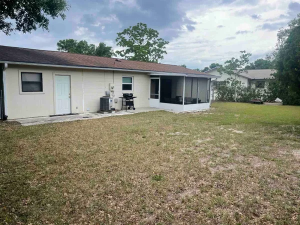 a view of a house with a yard and garage