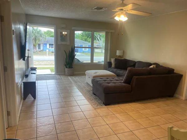 a living room with a couch and a chandelier