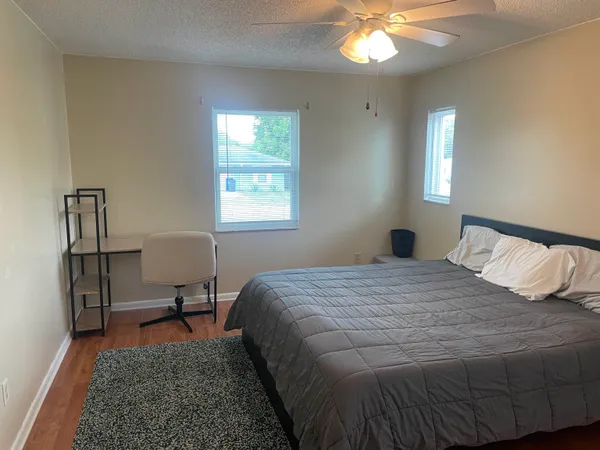 a bedroom with a bed and a chandelier