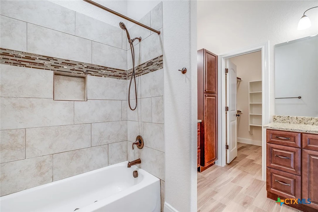 3133 Puter Creek Road, Unit B Spring Branch, TX 78070 - Photo 14 of 19 a bathroom with a tub sink and shower