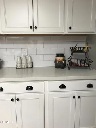 a kitchen with white cabinets and a white wooden cabinets