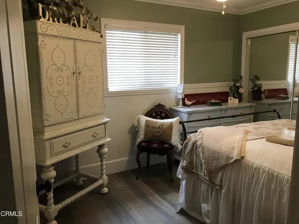 a bedroom with a bed and a night stand
