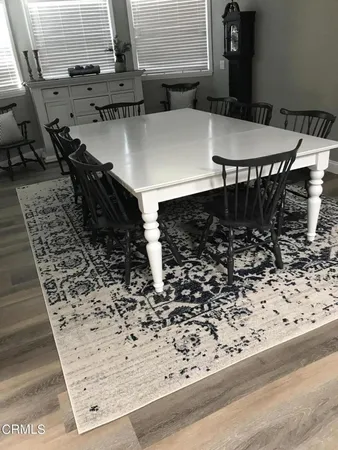 a view of a chairs and table in the backyard