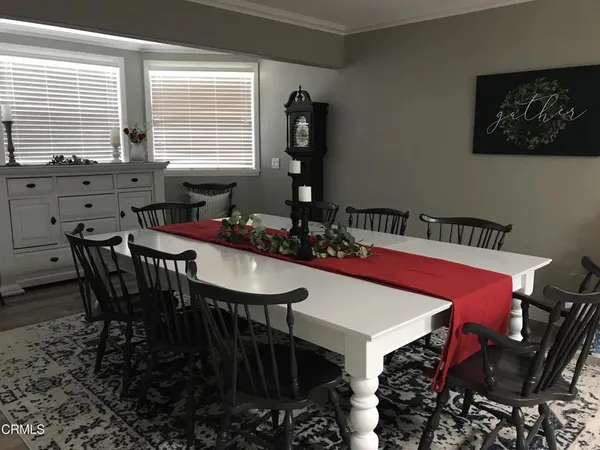 a view of a dining room with furniture and window