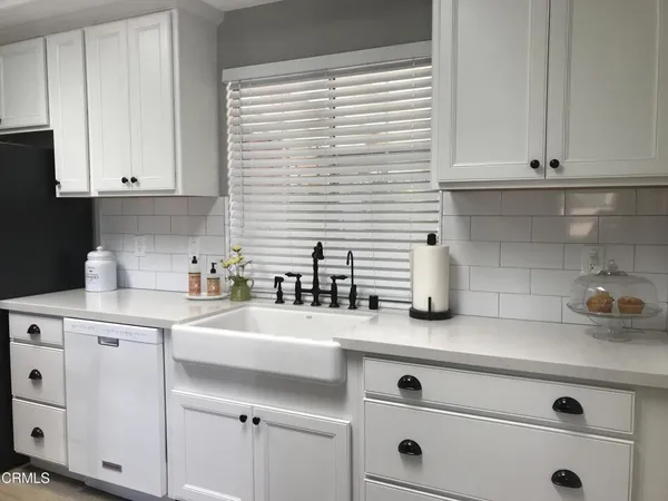 a kitchen with appliances cabinets and a window