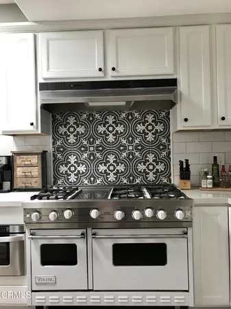 a stove top oven sitting inside of a kitchen