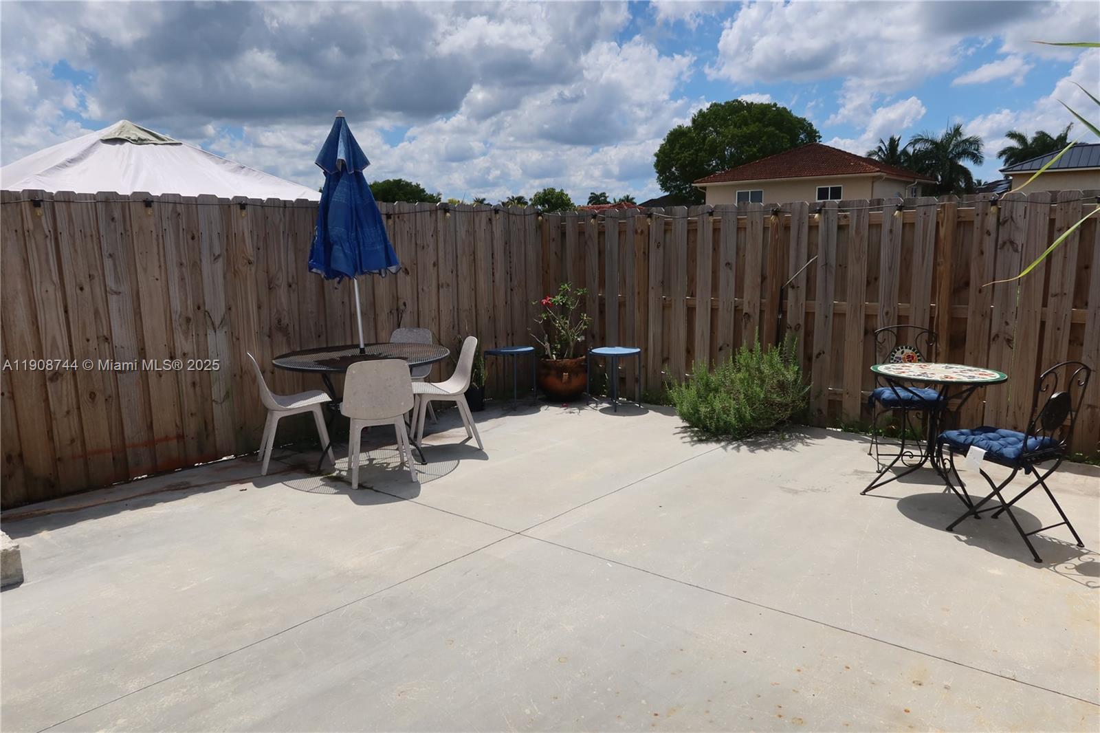 18240 Southwest 148th Road, Unit 18240 Miami, FL 33187 - Photo 11 of 30 a view of outdoor space with furniture and wooden fence