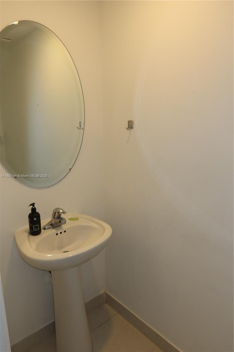 18240 Southwest 148th Road, Unit 18240 Miami, FL 33187 - Photo 14 of 30 a bathroom with a sink and a mirror