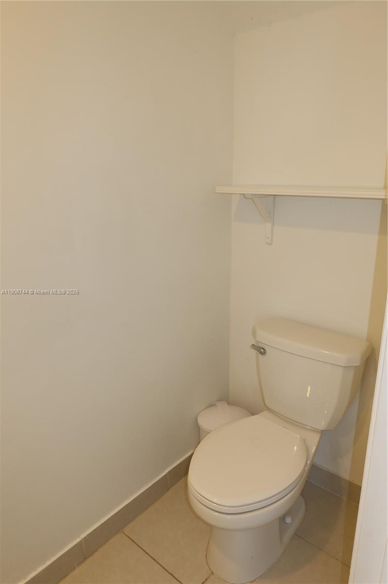 18240 Southwest 148th Road, Unit 18240 Miami, FL 33187 - Photo 15 of 30 a white toilet sitting next to a white sink