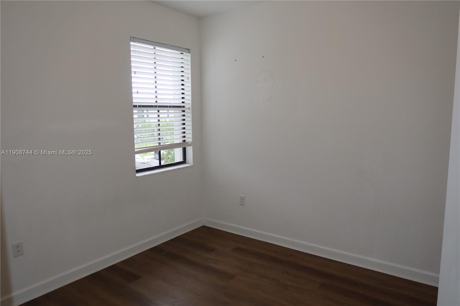 18240 Southwest 148th Road, Unit 18240 Miami, FL 33187 - Photo 17 of 30 an empty room with wooden floor and windows
