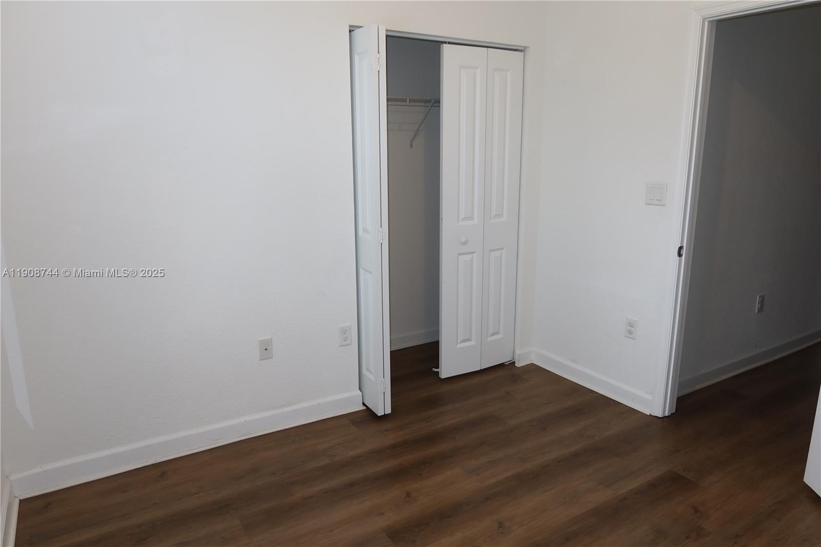 18240 Southwest 148th Road, Unit 18240 Miami, FL 33187 - Photo 20 of 30 a view of an empty room with wooden floor