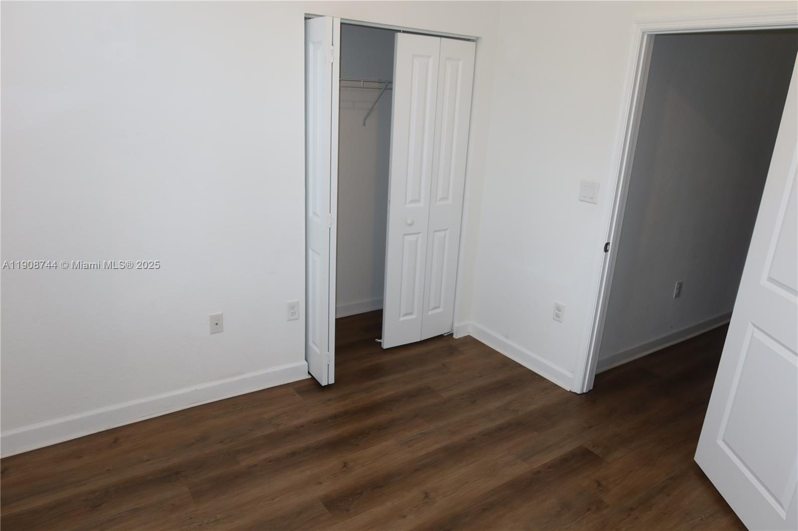18240 Southwest 148th Road, Unit 18240 Miami, FL 33187 - Photo 21 of 30 a view of an empty room with wooden floor