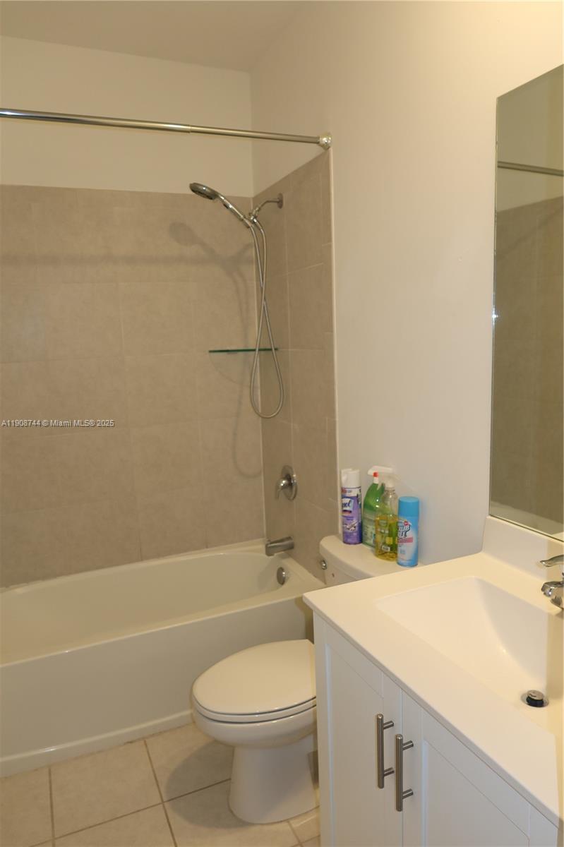 18240 Southwest 148th Road, Unit 18240 Miami, FL 33187 - Photo 23 of 30 a bathroom with a sink a toilet and shower