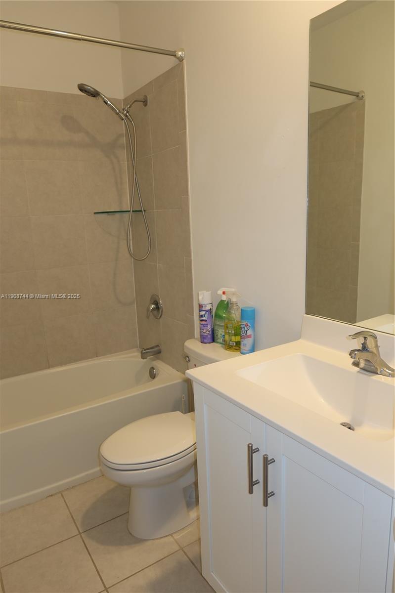 18240 Southwest 148th Road, Unit 18240 Miami, FL 33187 - Photo 24 of 30 a bathroom with a sink a toilet and shower