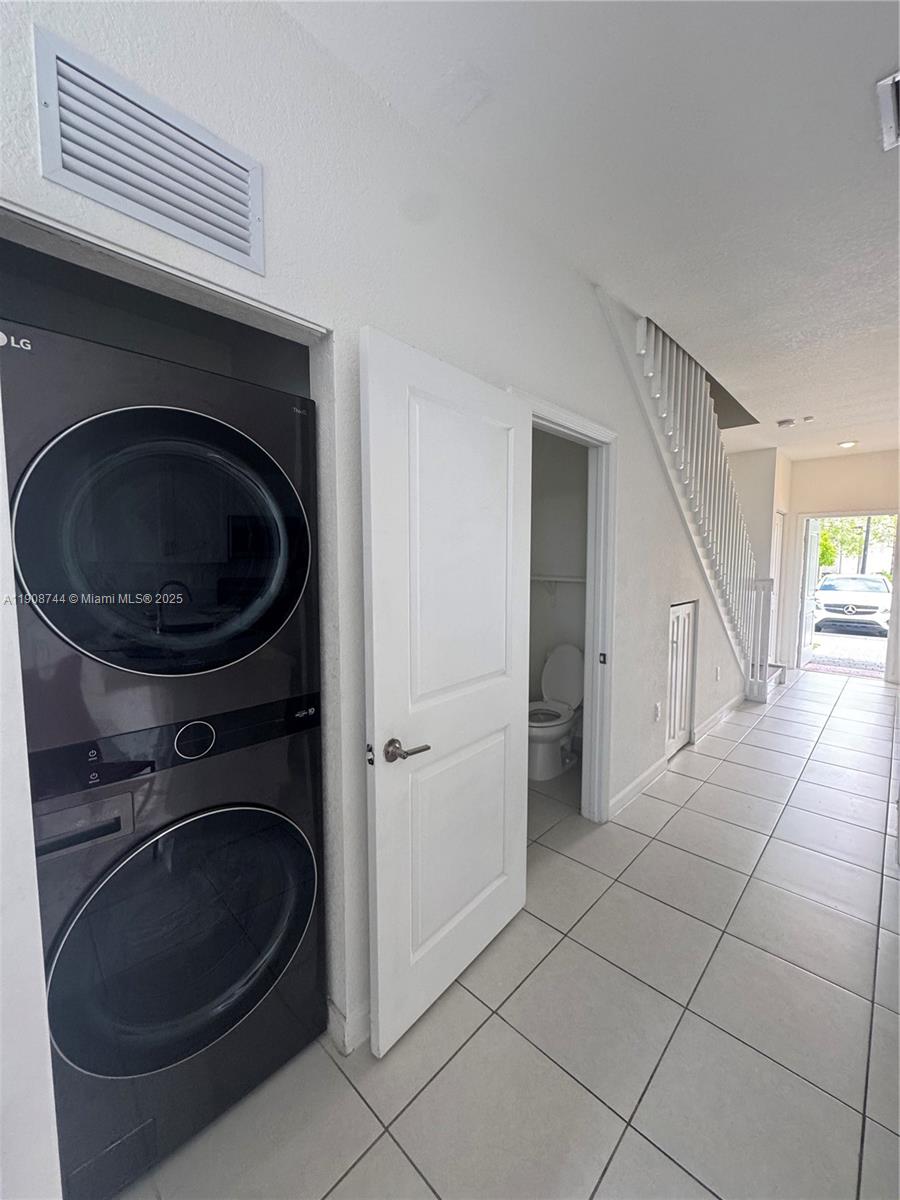 18240 Southwest 148th Road, Unit 18240 Miami, FL 33187 - Photo 3 of 30 a utility room with dryer and washer