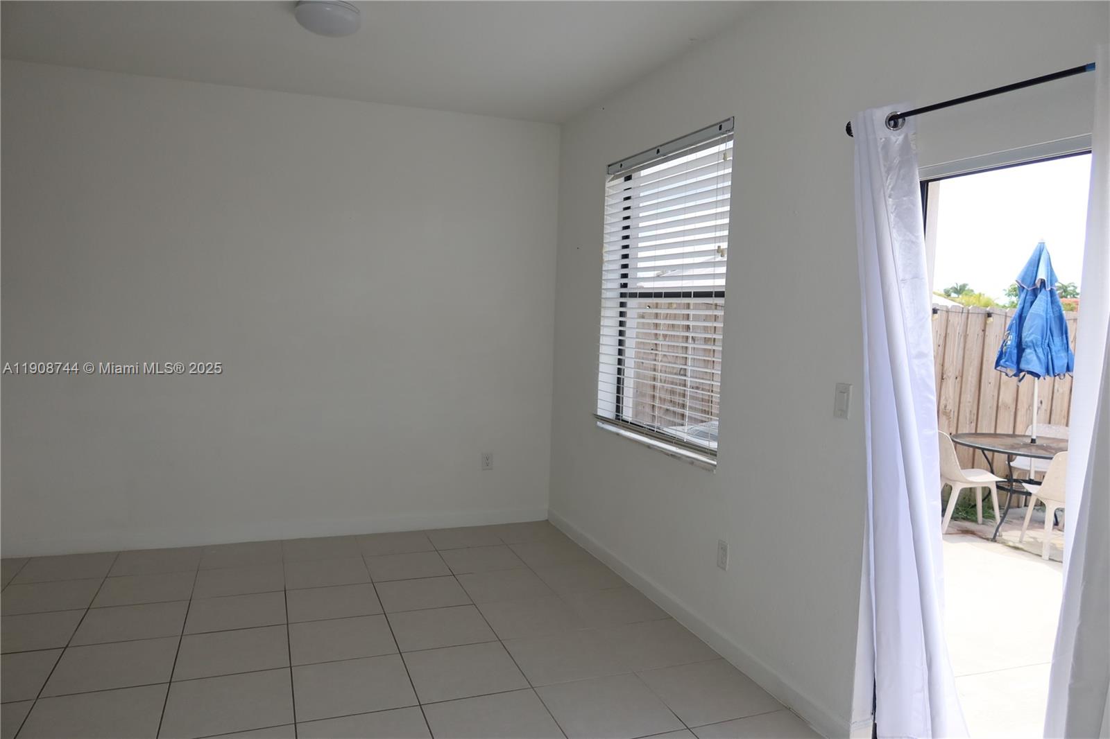 18240 Southwest 148th Road, Unit 18240 Miami, FL 33187 - Photo 7 of 30 an empty room with windows