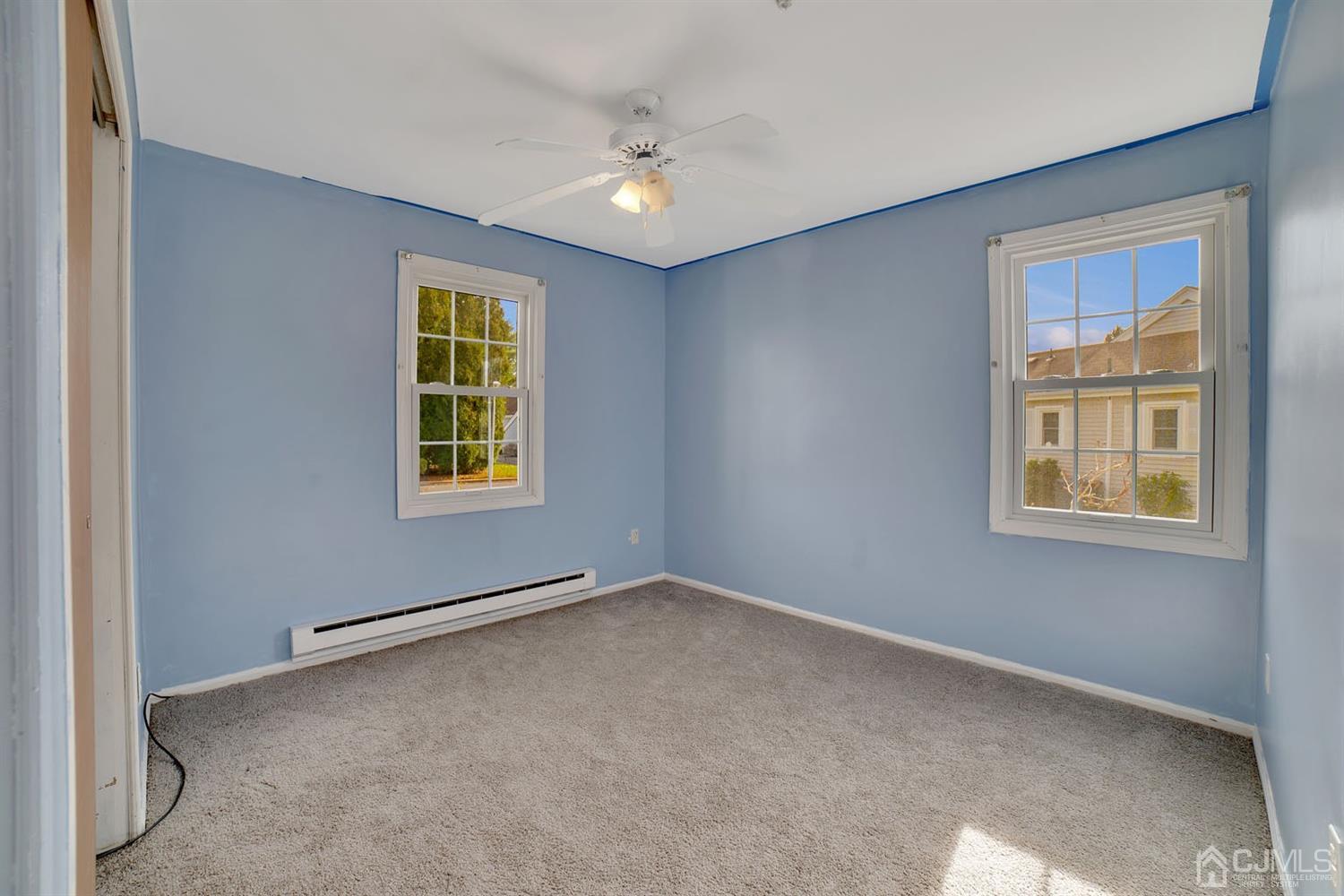 136 Rigi Strasse, Unit E Freehold, NJ 07728 - Photo 18 of 30 an empty room with windows