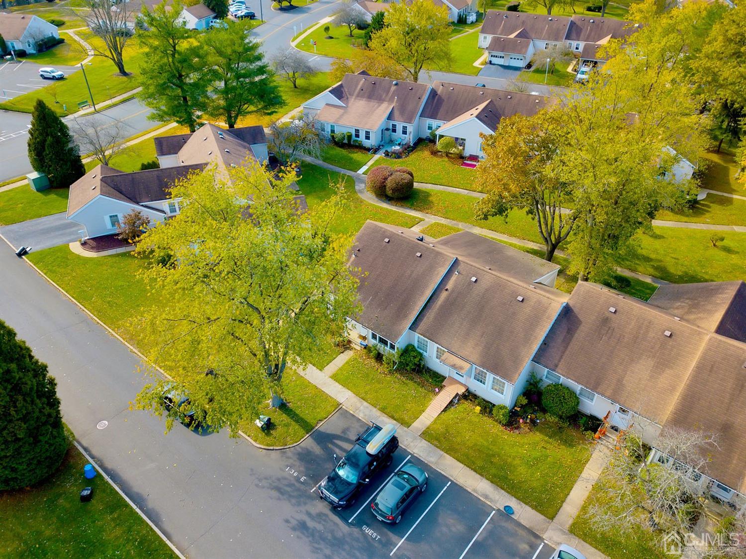 136 Rigi Strasse, Unit E Freehold, NJ 07728 - Photo 23 of 30 an aerial view of a house with a swimming pool