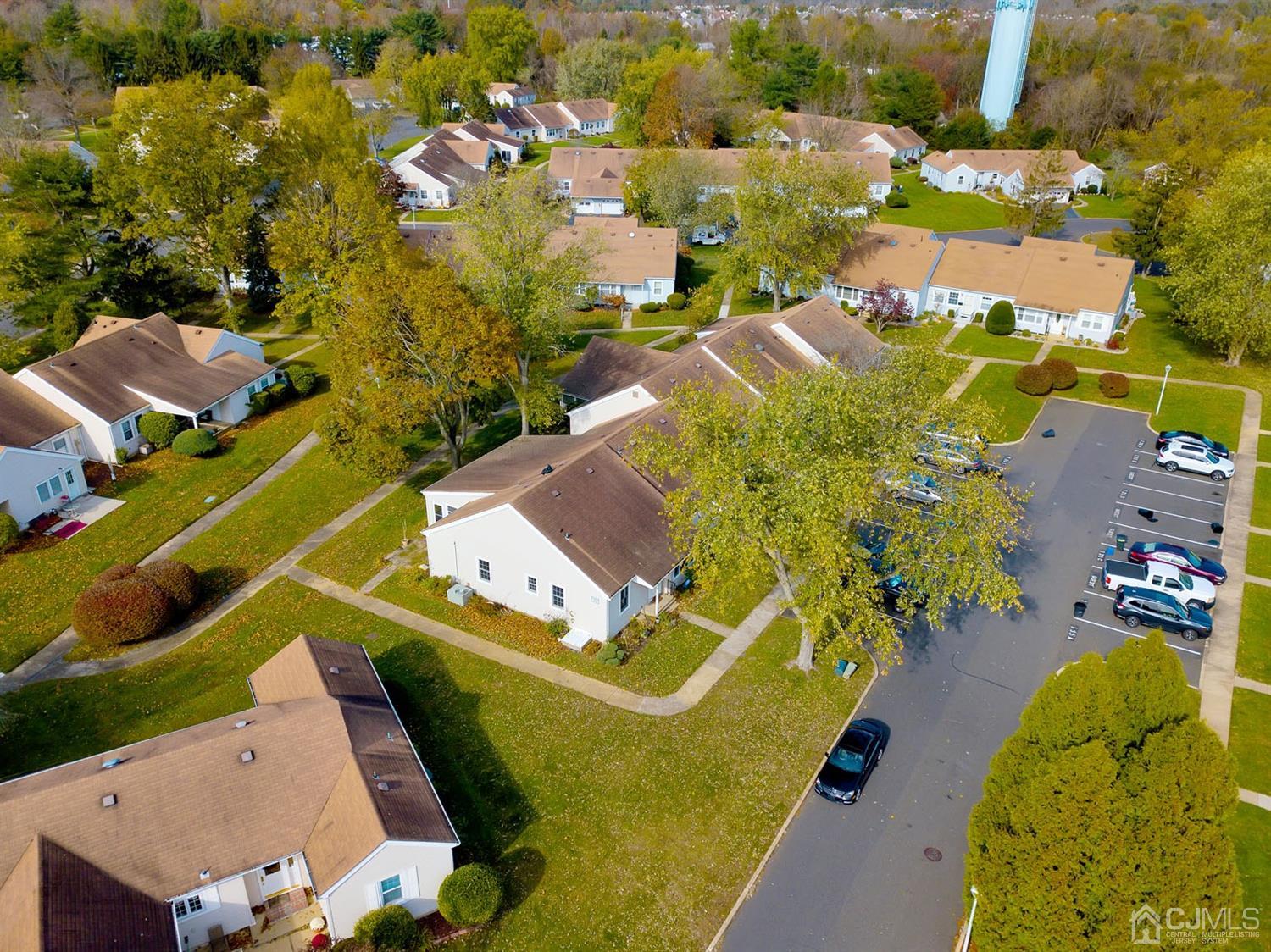 136 Rigi Strasse, Unit E Freehold, NJ 07728 - Photo 24 of 30 an aerial view of a house with a swimming pool yard and outdoor seating