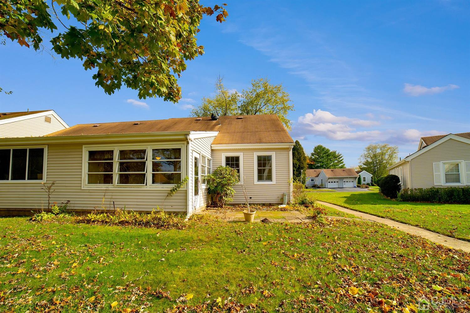 136 Rigi Strasse, Unit E Freehold, NJ 07728 - Photo 5 of 30 a front view of a house with garden