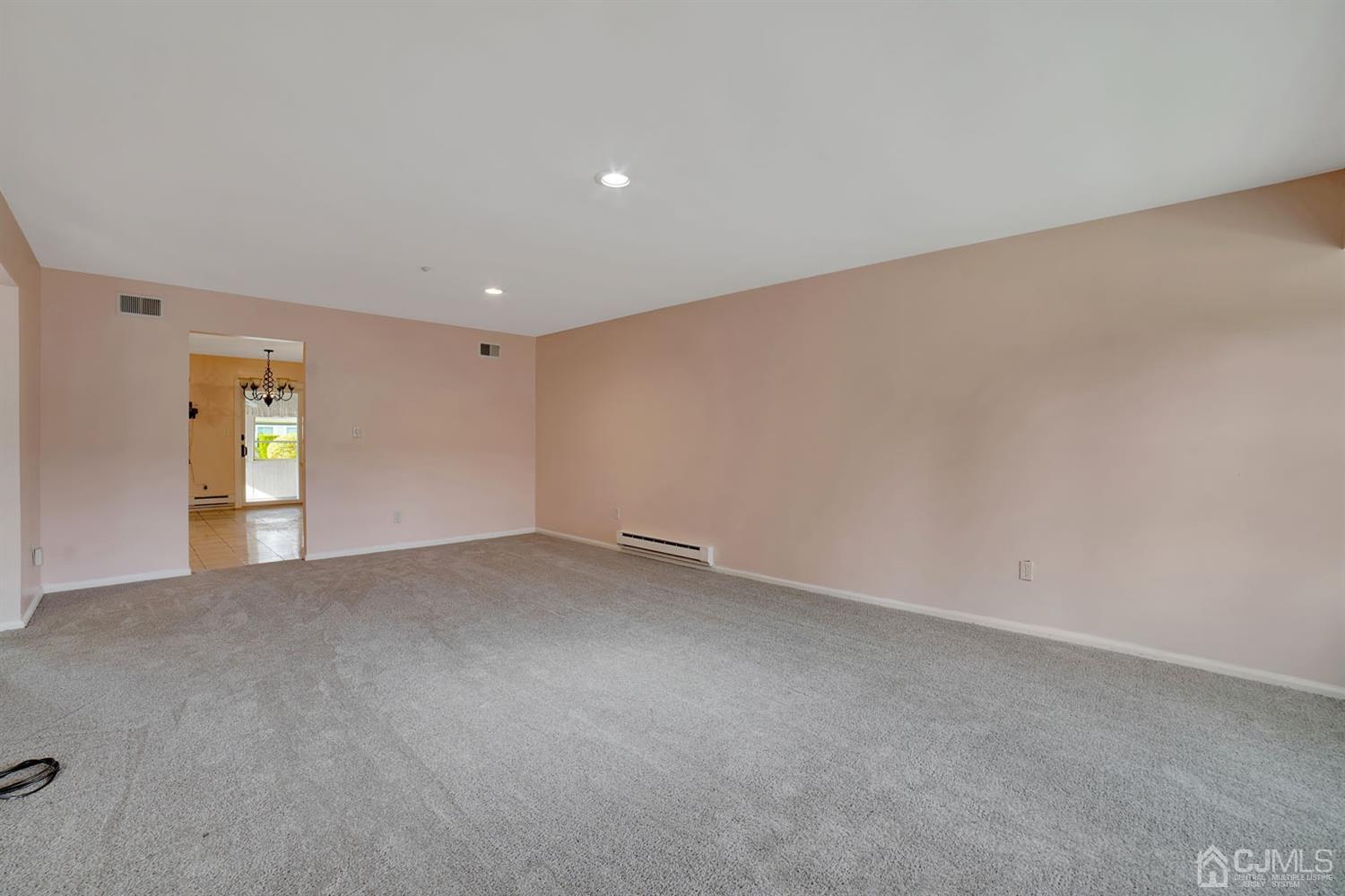 136 Rigi Strasse, Unit E Freehold, NJ 07728 - Photo 9 of 30 a view of an empty room with a window