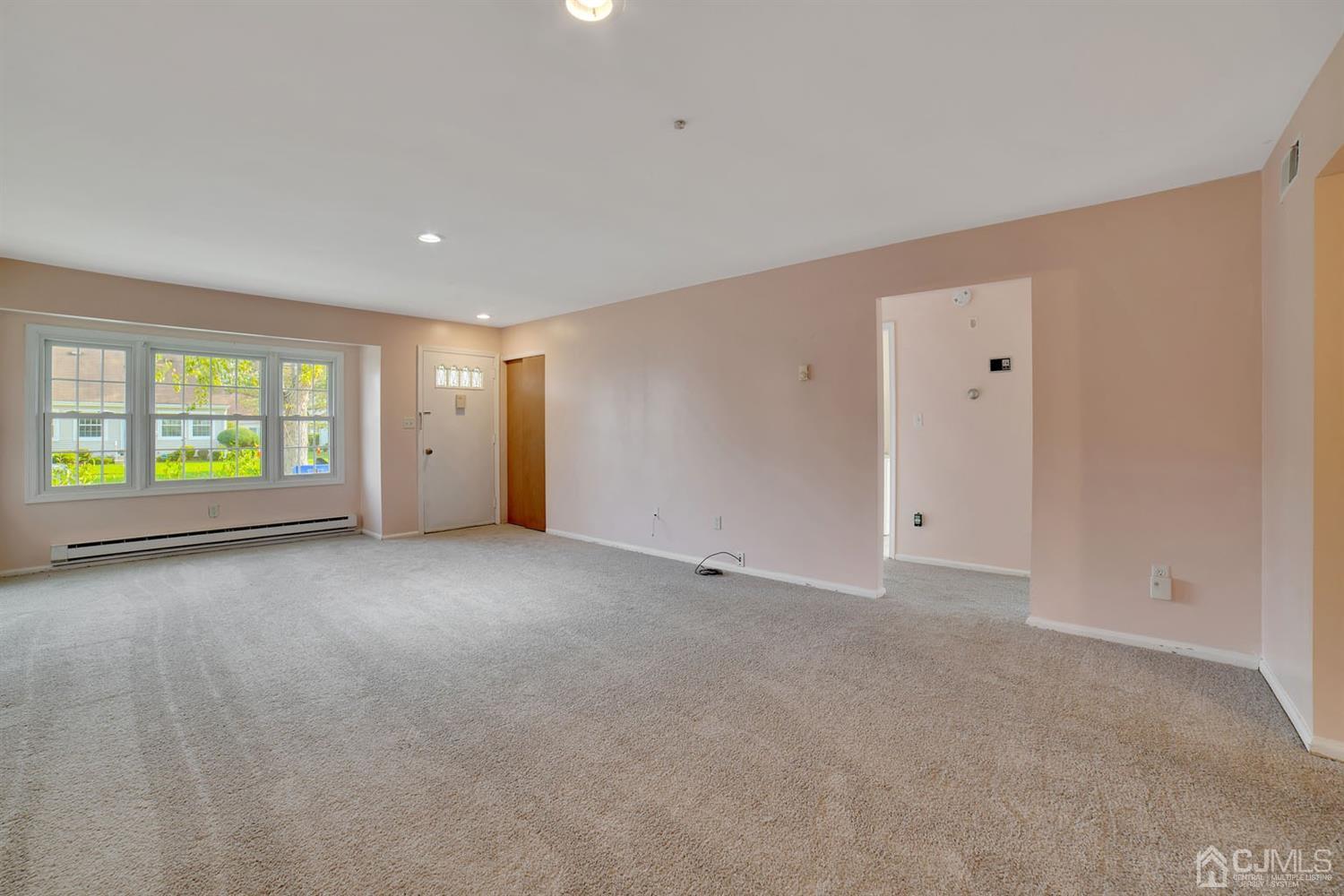 136 Rigi Strasse, Unit E Freehold, NJ 07728 - Photo 10 of 30 a view of an empty room with a window