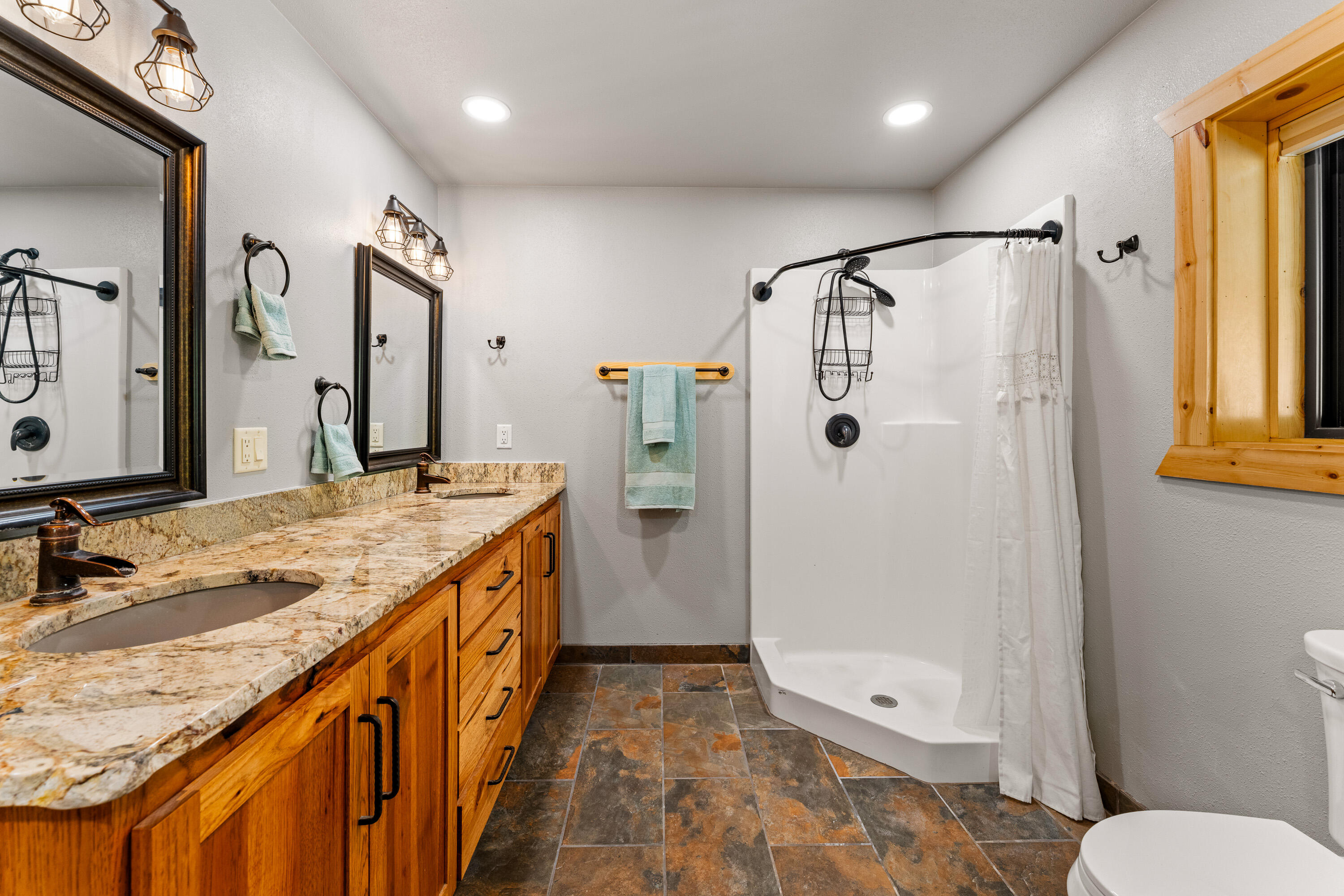 225 Eagle Ridge Road Canyonville, OR 97417 - Photo 40 of 52 a bathroom with a granite countertop sink toilet and shower