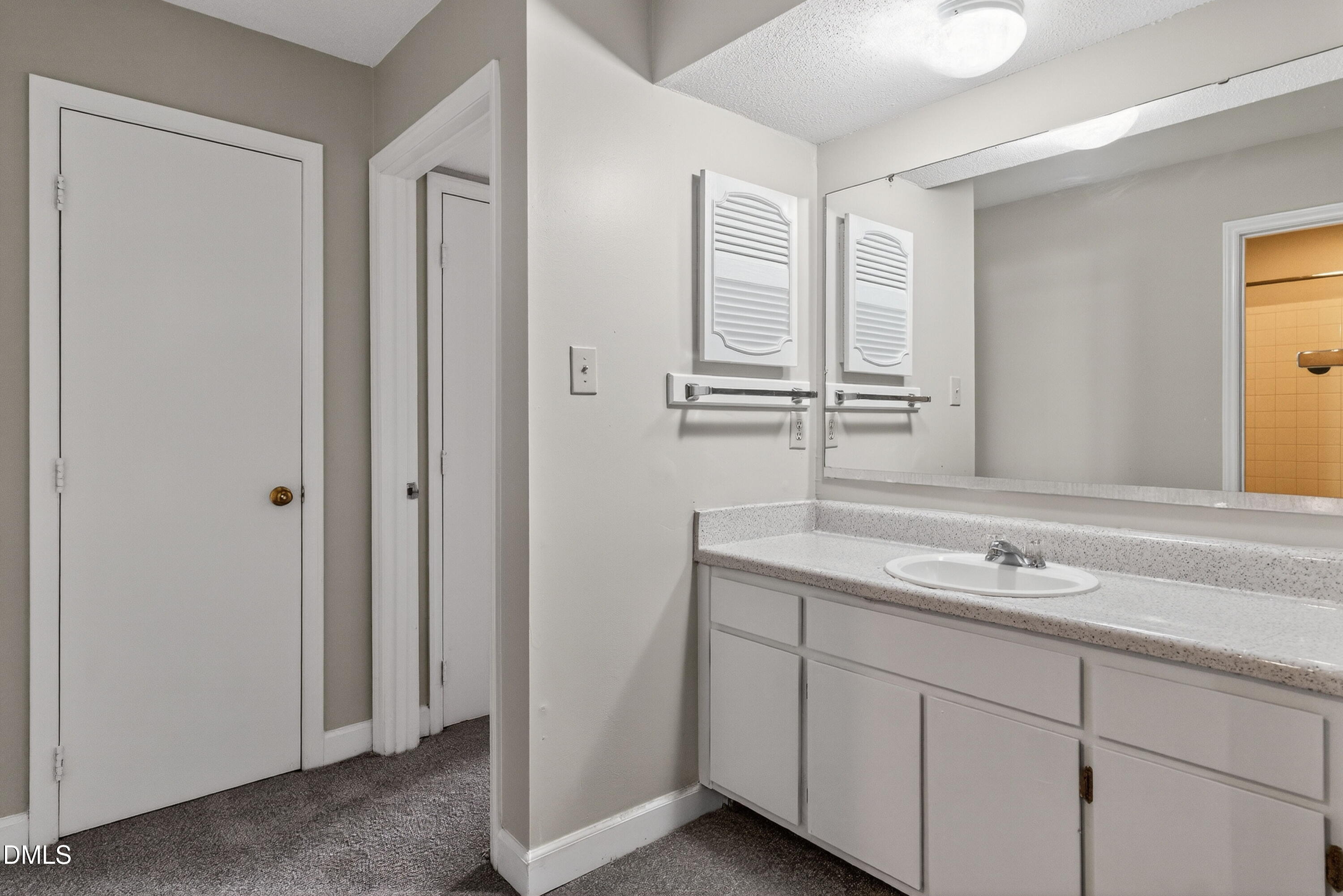 2510 Avent Ferry Road, Unit 104 Raleigh, NC 27606 - Photo 18 of 26 a bathroom with a granite countertop sink and a mirror