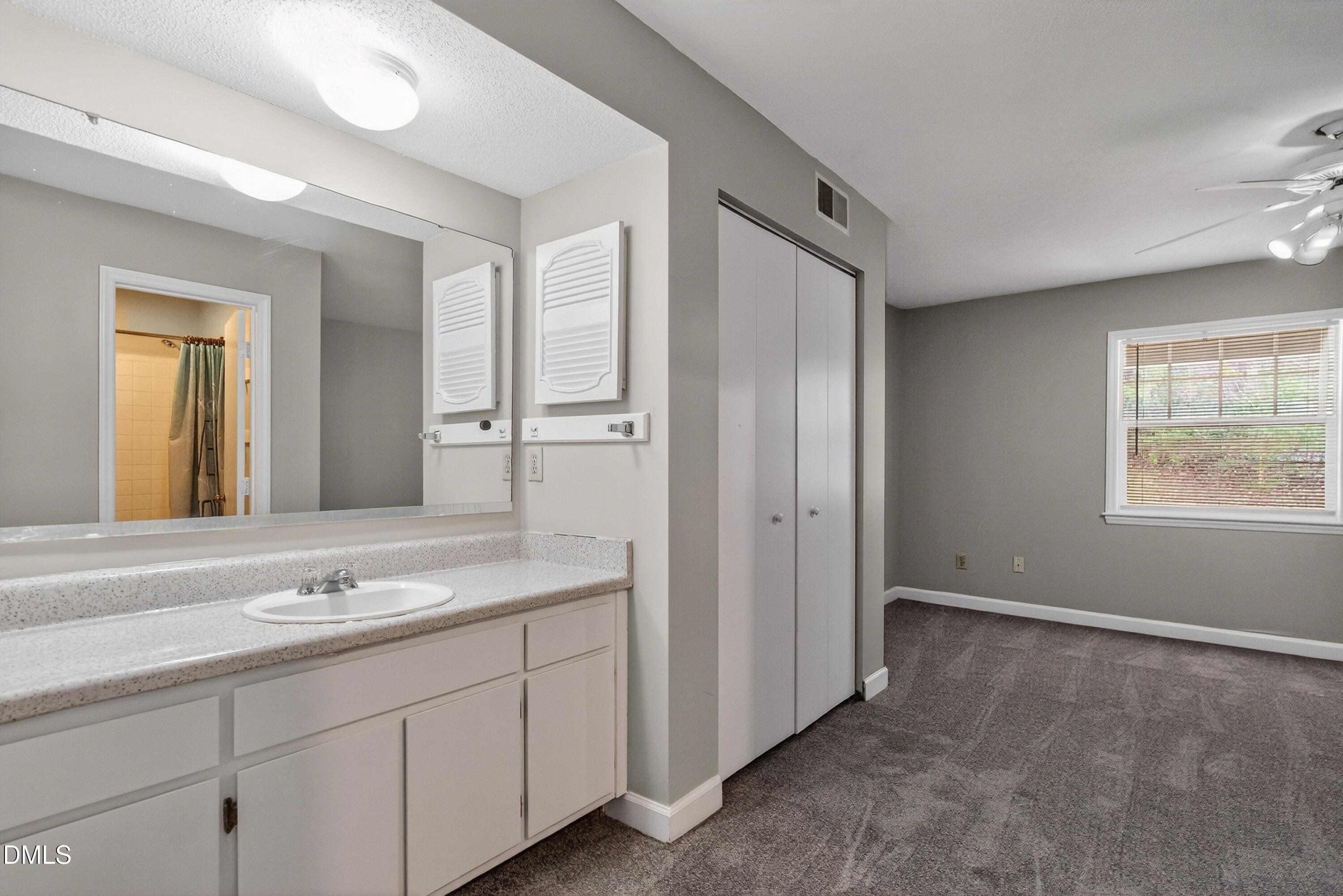 2510 Avent Ferry Road, Unit 104 Raleigh, NC 27606 - Photo 22 of 26 a spacious bathroom with a granite countertop sink and a mirror