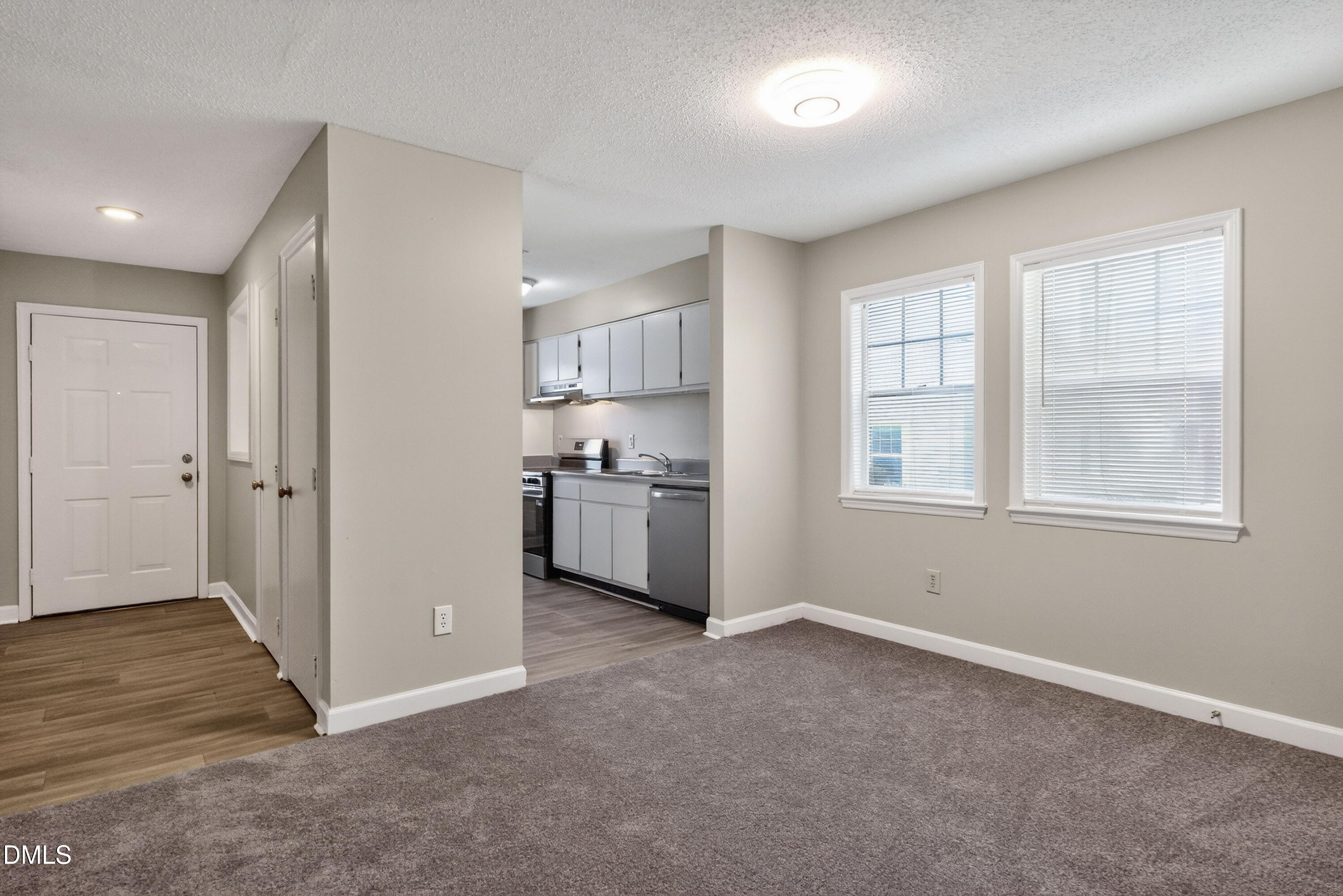 2510 Avent Ferry Road, Unit 104 Raleigh, NC 27606 - Photo 6 of 26 a view of a kitchen with wooden floor and electronic appliances