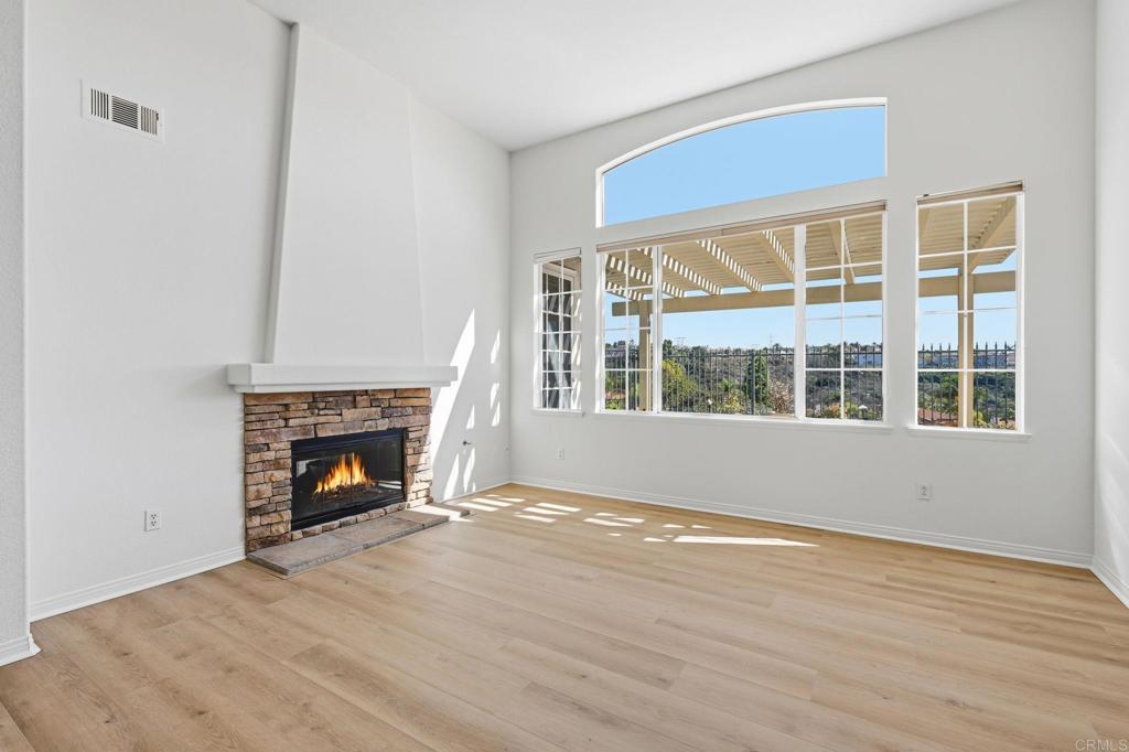 1359 Sparrow Road Carlsbad, CA 92011 - Photo 11 of 43 a view of an empty room with wooden floor fireplace and a window