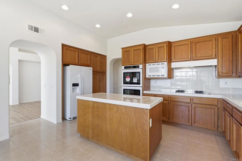 1359 Sparrow Road Carlsbad, CA 92011 - Photo 13 of 43 a large kitchen with stainless steel appliances granite countertop a refrigerator and a sink