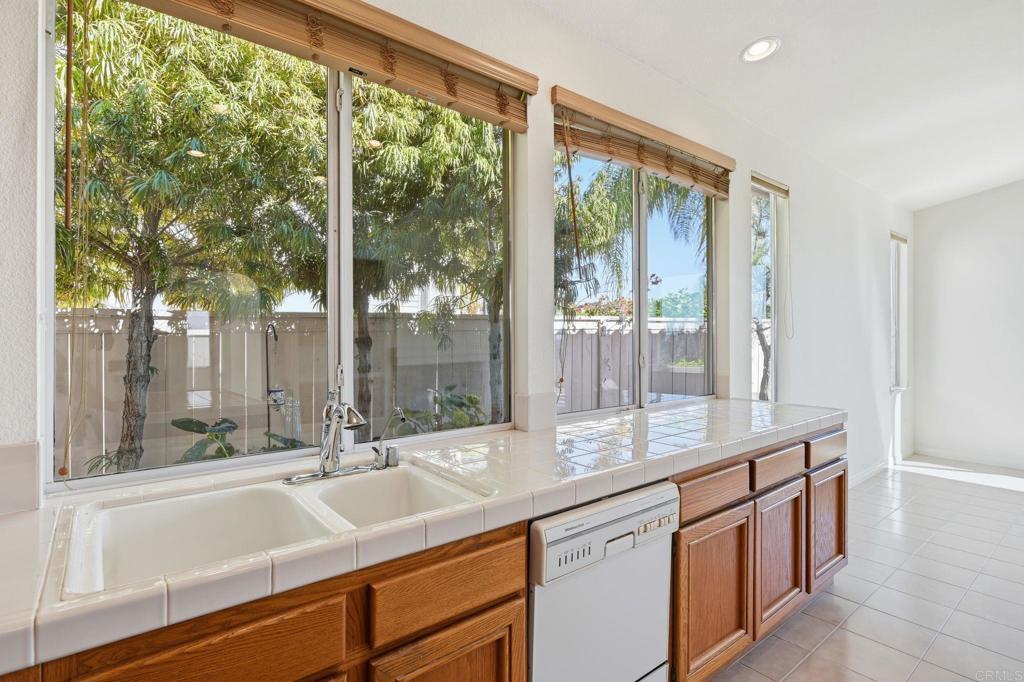 1359 Sparrow Road Carlsbad, CA 92011 - Photo 14 of 43 a bathroom with a sink and a large mirror next to a window