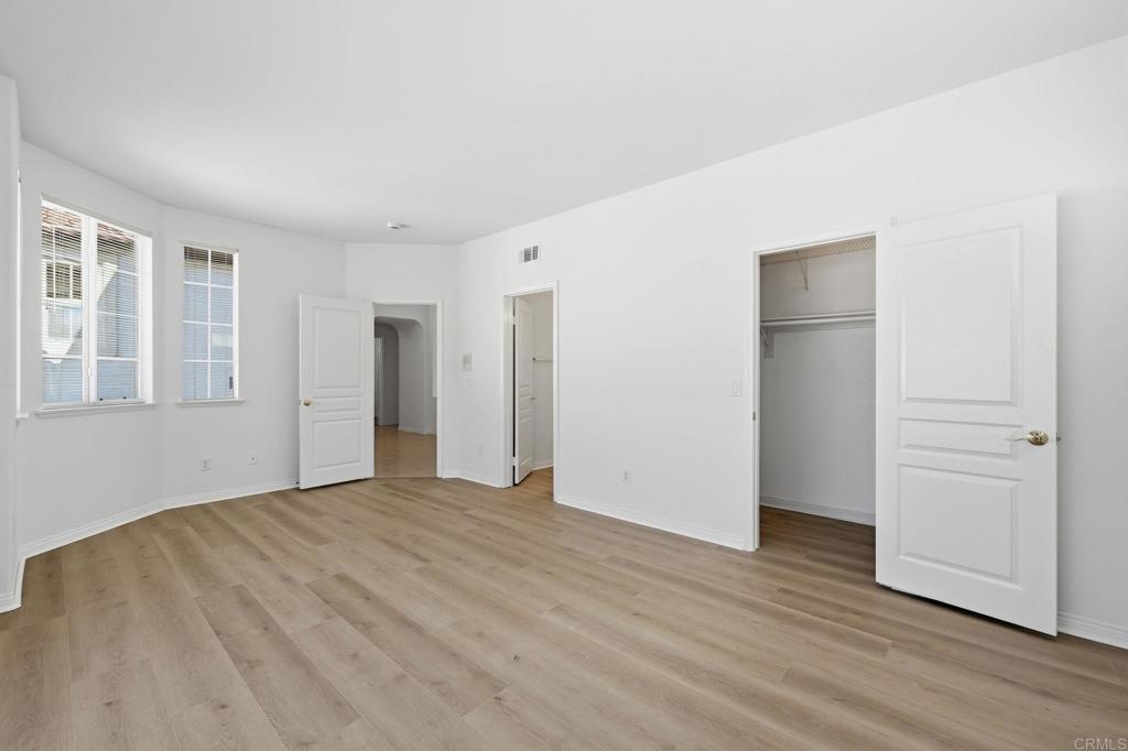 1359 Sparrow Road Carlsbad, CA 92011 - Photo 29 of 43 a view of an empty room with wooden floor and windows