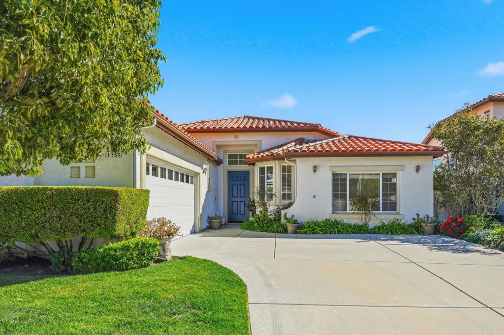 1359 Sparrow Road Carlsbad, CA 92011 - Photo 3 of 43 a front view of a house with a garden