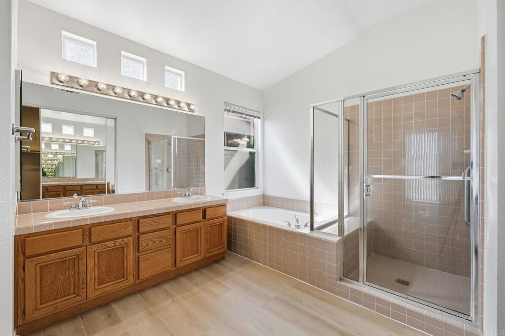1359 Sparrow Road Carlsbad, CA 92011 - Photo 35 of 43 a spacious bathroom with a shower sink and mirror
