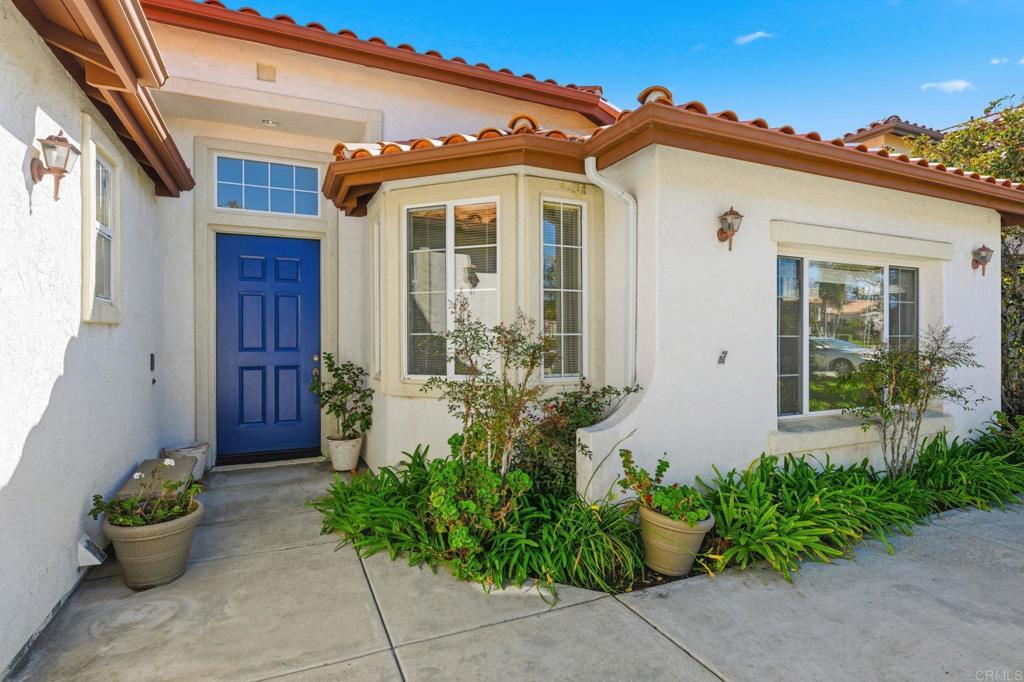 1359 Sparrow Road Carlsbad, CA 92011 - Photo 4 of 43 a front view of a house with potted plants