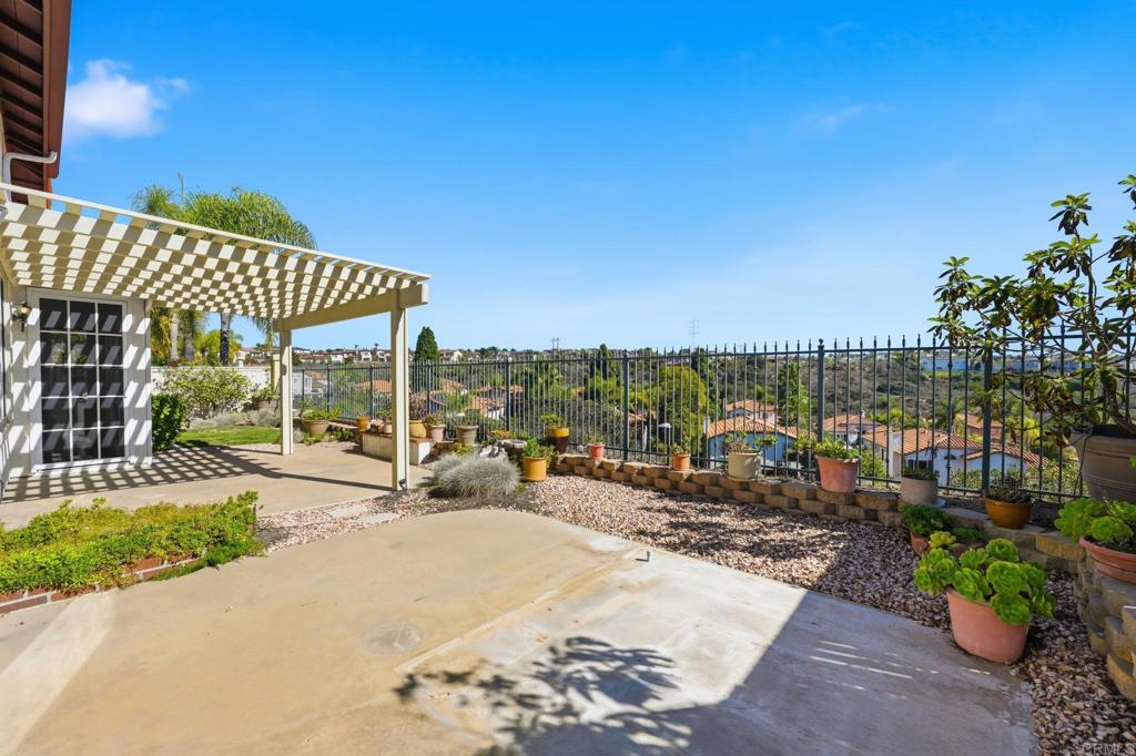 1359 Sparrow Road Carlsbad, CA 92011 - Photo 41 of 43 a view of a patio with a table and chairs under an umbrella