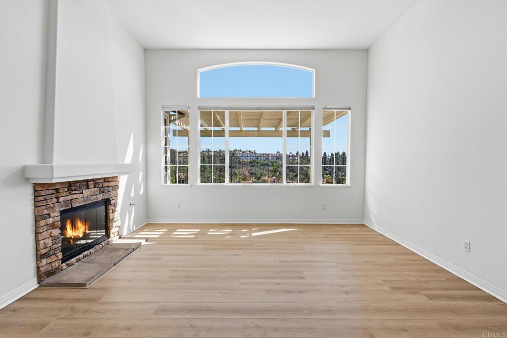 1359 Sparrow Road Carlsbad, CA 92011 - Photo 10 of 43 a view of an empty room with wooden floor fireplace and a window
