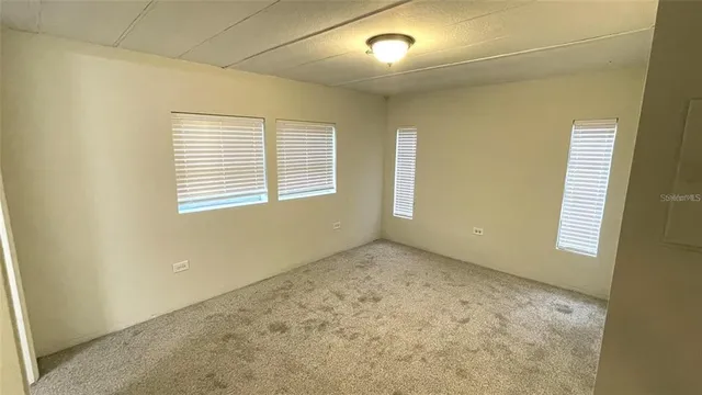 an empty room with a empty space and windows