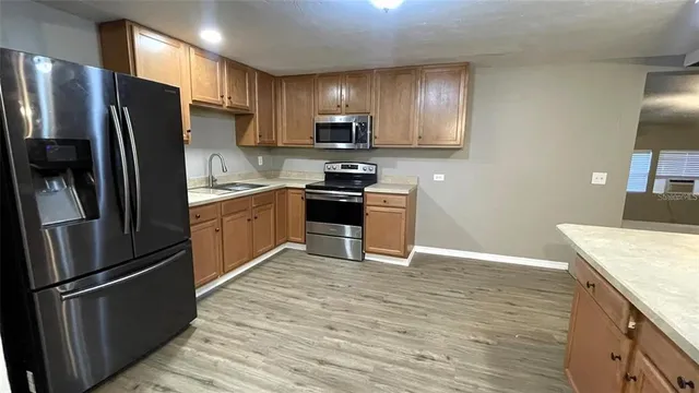 a kitchen with granite countertop stainless steel appliances and wooden cabinets