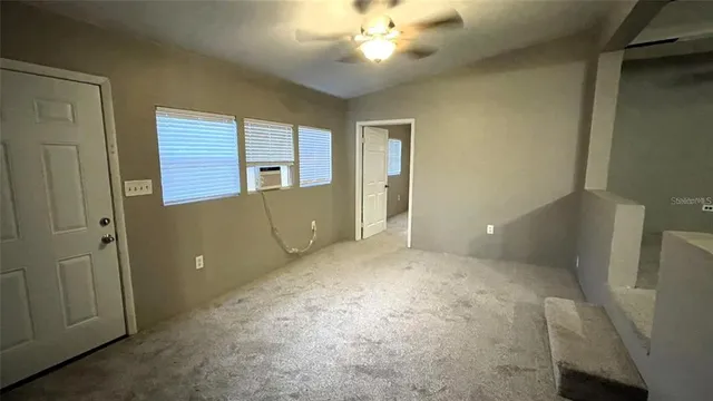 a view of an empty room with a window