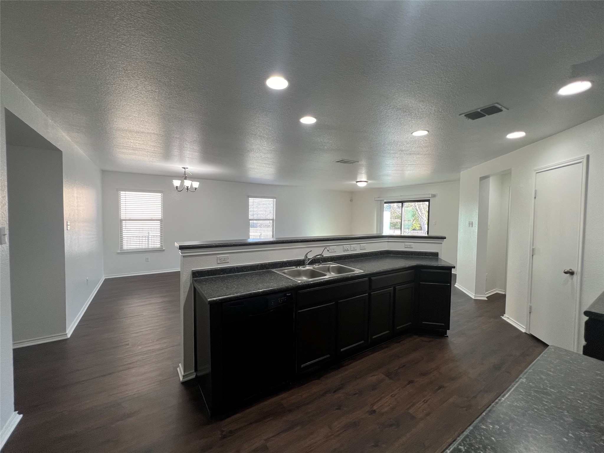 270 Sheep Trail Drive Kyle, TX 78640 - Photo 12 of 27 a large kitchen with a stove and a wooden floors
